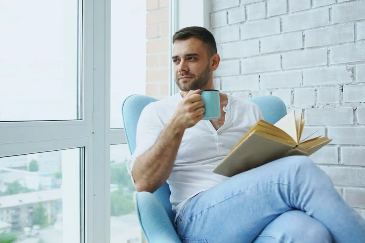 Quiet moment reading by a window with coffee — no social feed required